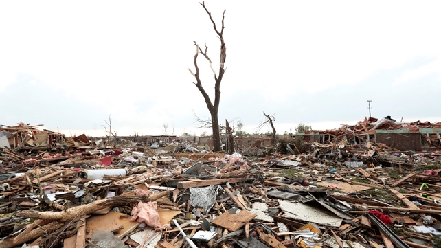 Massive piles of debris cover the ground after the tornado ripped through Moore