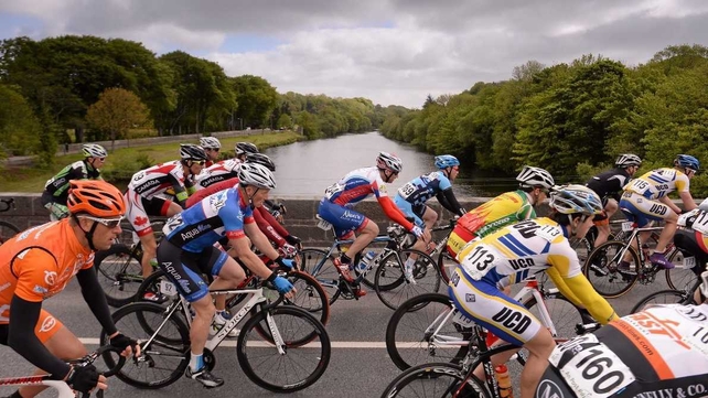 The peloton crosses the bridge leaving Listowel, Co Kerry