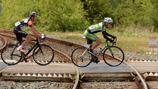 Right to left: Shane Archbold (An Post Chain Reaction) and Michael Northey (NODE4 Giordana) cross a level crossing at Banteer, Co Cork