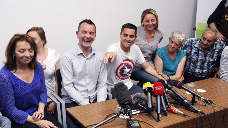 Vincent Aubin and Bruon Boileau (centre) are the first couple to marry under France's new law