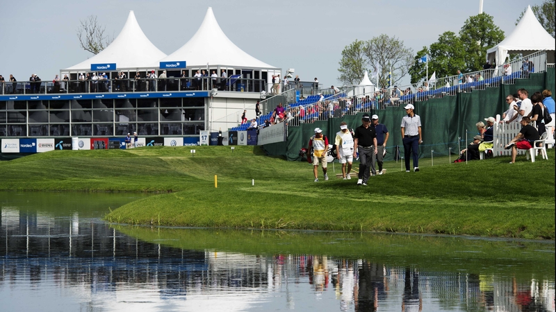 Miguel Angel Jimenez (c), Matteo Manassero (r) and Peter Hanson (second-r) walk to the 17th green