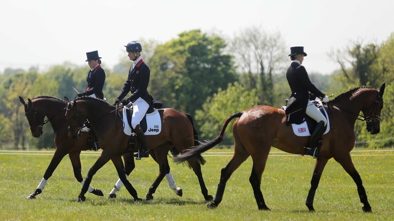 Britain's Sarah Bullimore on Reve de Rouet passes Pippa Funnell and William Fox-Pitt in the warm up area
