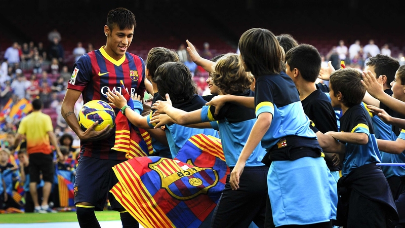 Neymar is mobbed at his unveiling at Barcelona's Camp Nou Stadium