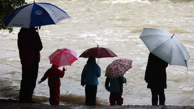 People watch the rising Lech river in Landsberg am Lech, Germany