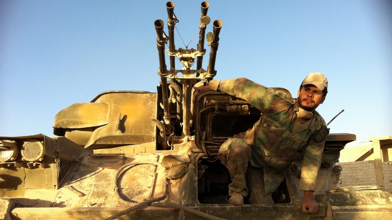 A Syrian soldier comes out of his tank as the army retakes Qusair