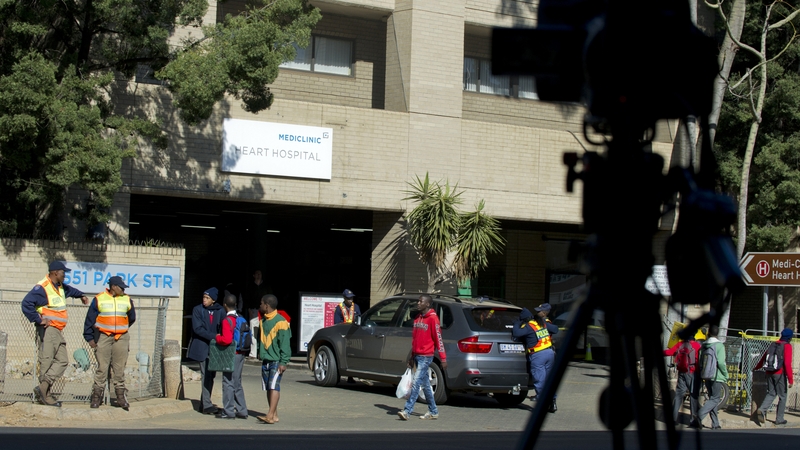 Police officers stand guard outside the hospital where Nelson Mandela is being treated