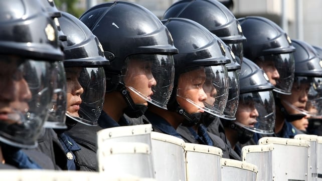 Japanese riot police stand guard during a protest march in Sapporo before the 2008 G8 summit