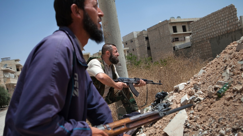 Syrian rebel fighters hold position in the northwestern town of Maaret al-Numan
