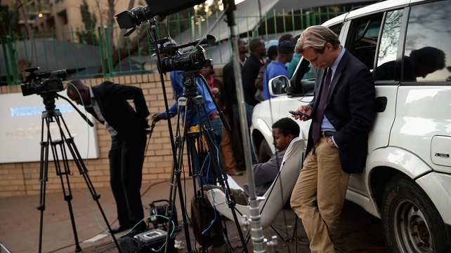 Members of the media wait outside the hospital in Pretoria, South Africa, where Nelson Mandela is being treated