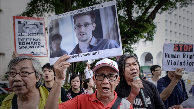 Protesters shout slogans in support of US whistleblower Edward Snowden as they march to the US consulate in Hong Kong