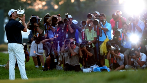 Justin Rose holds the US Open trophy aloft at Merion