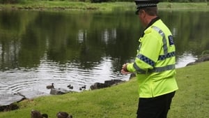 A police officer feeds ducks close to the Kellyhevlin Hotel which is being used as the G8 media centre