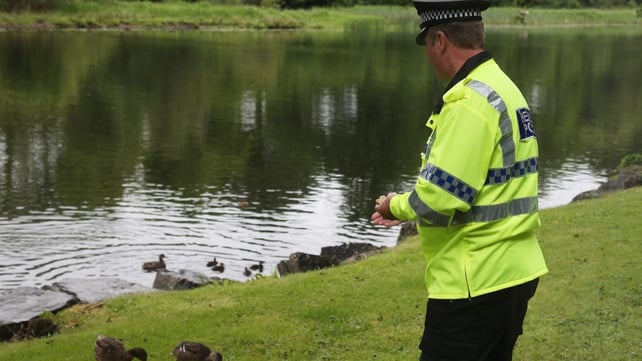 A police officer feeds ducks close to the Kellyhevlin Hotel which is being used as the G8 media centre