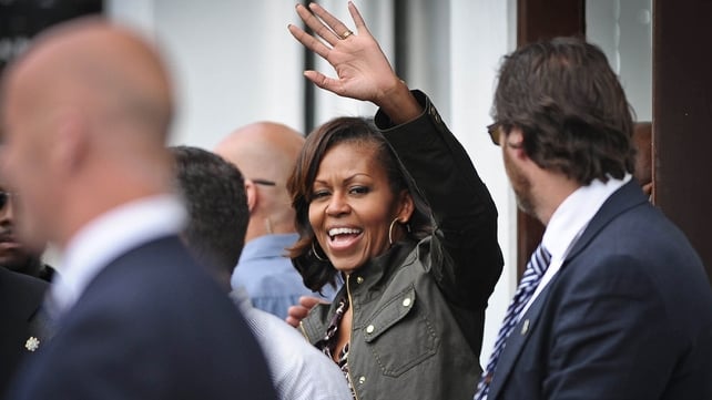 Mrs Obama waves to the crowds following lunch at Finnegan's pub