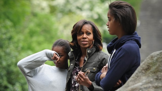 Sasha Obama battled with the midges, while her mother and sister listen to the tour guide
