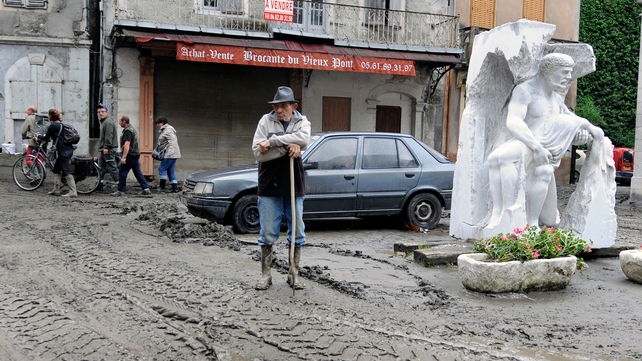 A villager takes a rest from the clean-up operation in Saint-Beat