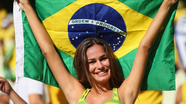 A Brazil fan cheers on her team to victory in the Confederations Cup