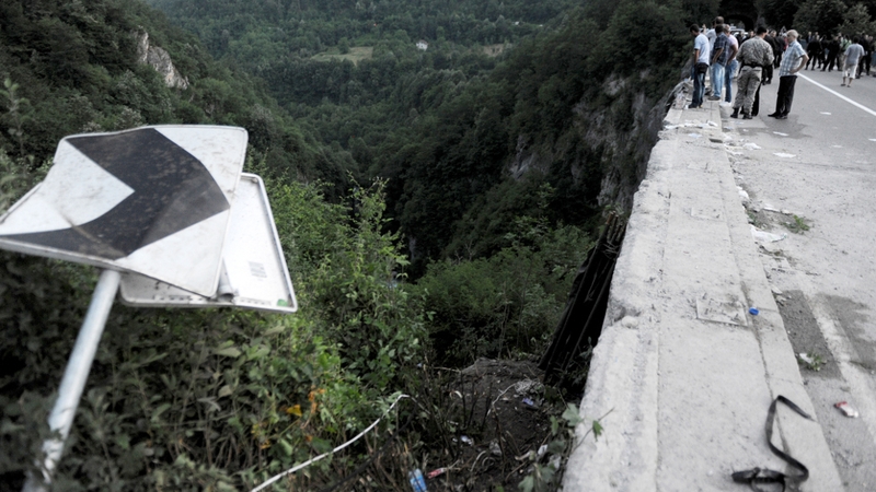 Onlookers at the scene where a bus crashed into a gorge in Montenegro yesterday, leaving 18 people dead