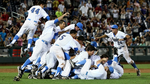 UCLA Bruins jump into a pile to celebrate after getting the final out against the Mississippi State Bulldogs during game two of the College World Series Finals