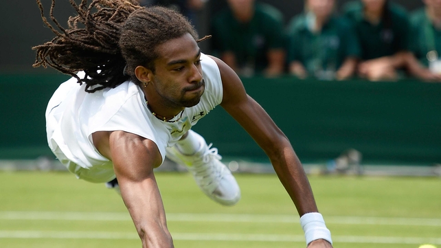 Dustin Brown of Germany dives to return a shot during his second-round match against Lleyton Hewitt at Wimbledon