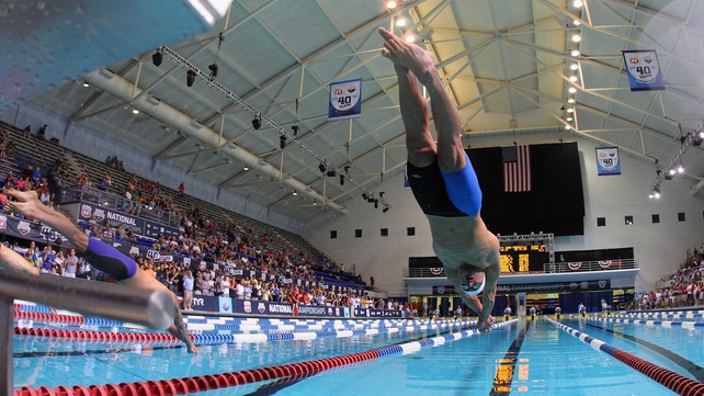 Nathan Adrian dives in on his way to winning the men's 100m freestyle finals at the USA Swimming National Championships