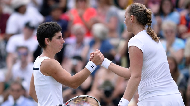 Petra Kvitova shakes hands at the net with Carla Suarez Navarro