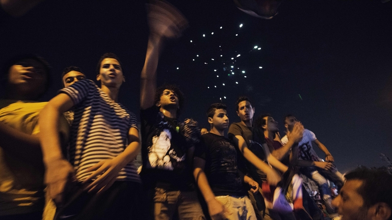 Egyptians shout slogans against President Mohammed Mursi outside the Presidential Palace in Cairo