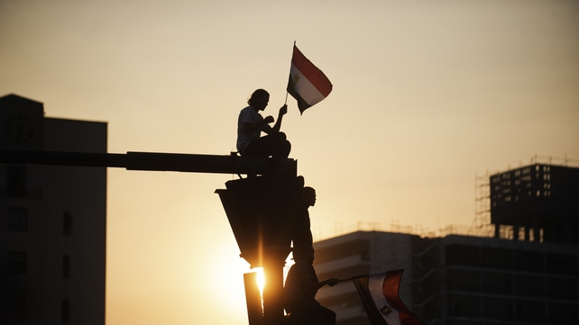 Eyptian protesters cheer on top of crosslight as hundreds of thousands take to the streets