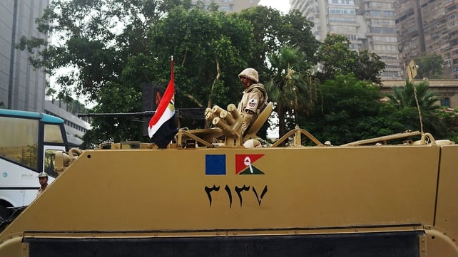 Egyptian military stands guard at a roadblock in the district of Giza