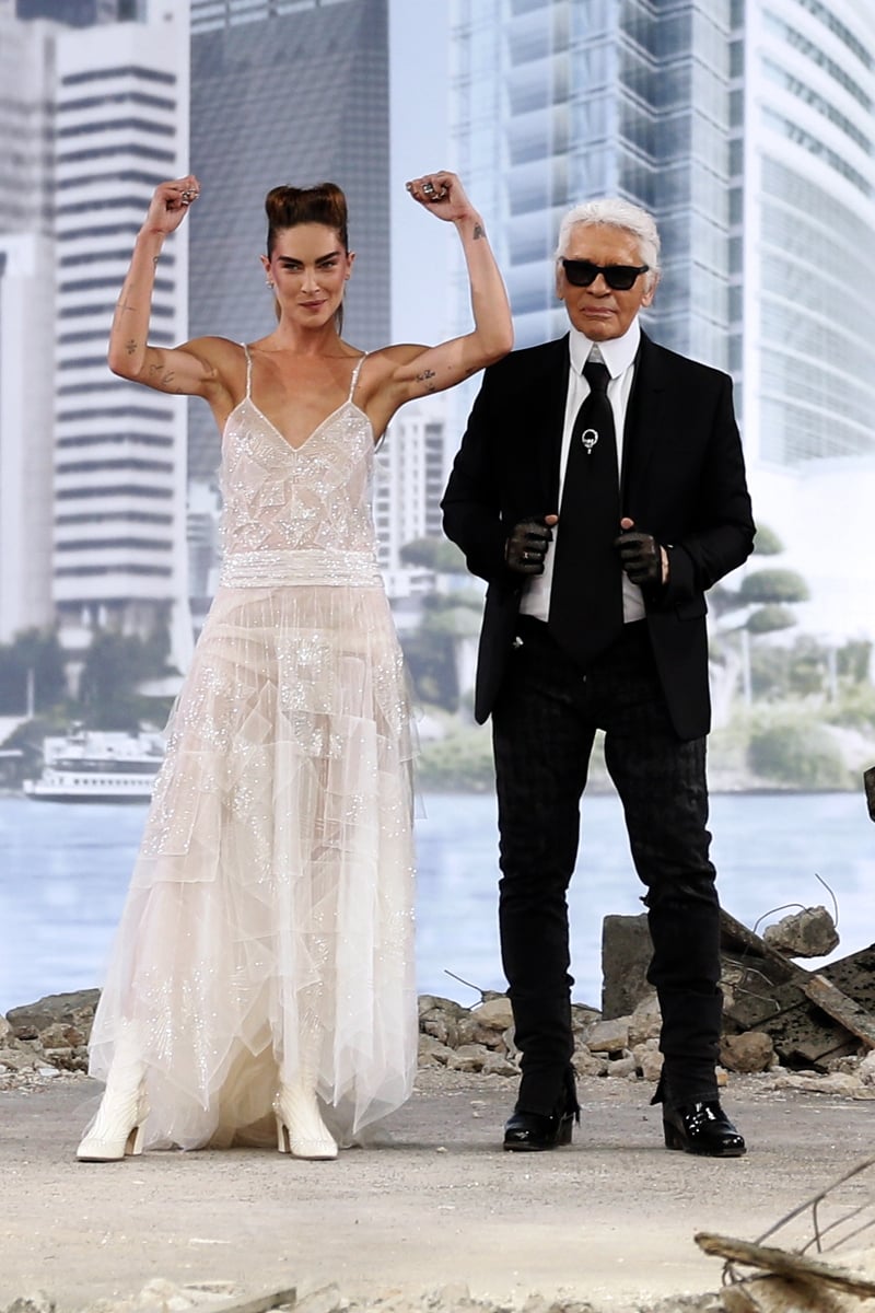 Erin Wasson shows off her impressive guns as she closes the Chanel show with Karl Lagerfeld