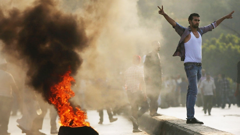 Supporters of Mohammed Mursi burn tyres on a bridge in Cairo in protest over his removal