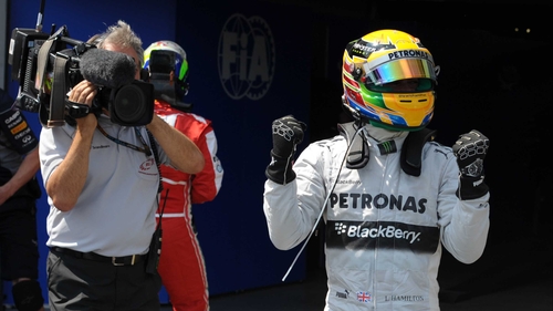 Lewis Hamilton shows his delight at earning pole position ahead of Sebastian Vettel