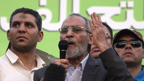 Mohamed Badie (C) faces charges of inciting violence