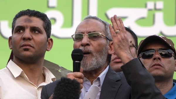 Mohamed Badie (C) faces charges of inciting violence