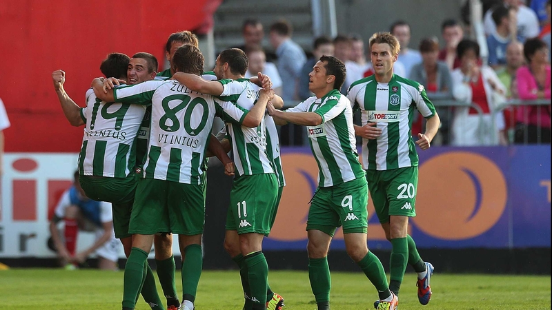 Zalgiris players celebrate after scoring their crucial second goal at Richmond Park