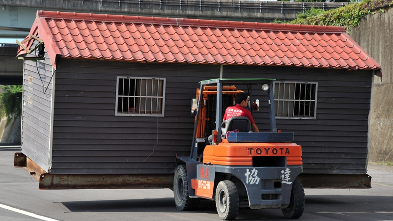 A worker moves a ticket booth from the Yanping Riverside Park in Taipei