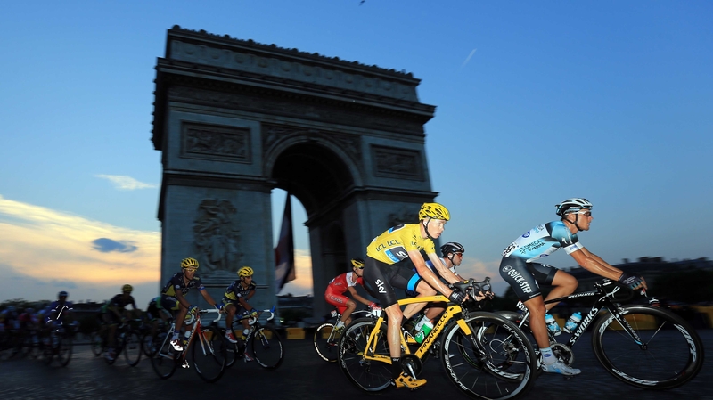 Chris Froome in the famous yellow jersey rounds the Arc d'Triomphe on his way to winning in Paris