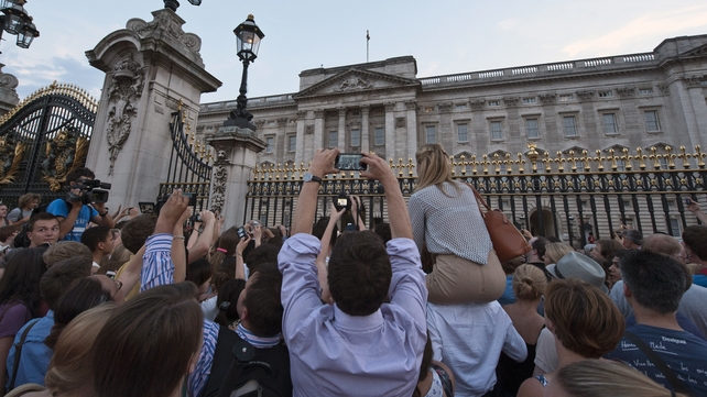 Well-wishers at Buckingham Palace strain to catch a view of the royal baby announcement