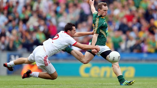 Eamonn Wallace of Meath scores the first goal of the game despite the challenge of Ryan McKenna of Tyrone in their round four qualifier