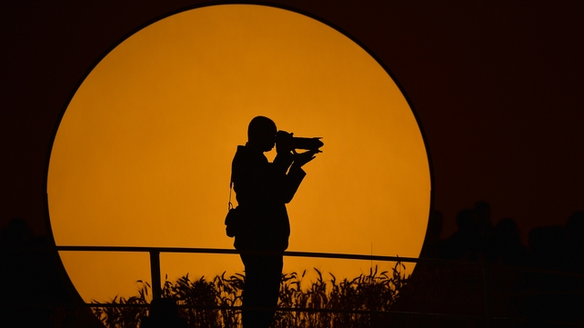 A photographer caught in the eye of the camera at Copacabana beach