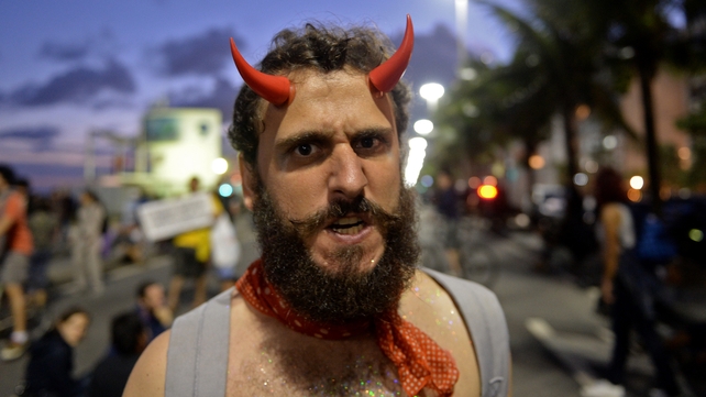 A man protests against the Catholic Church at Copacabana