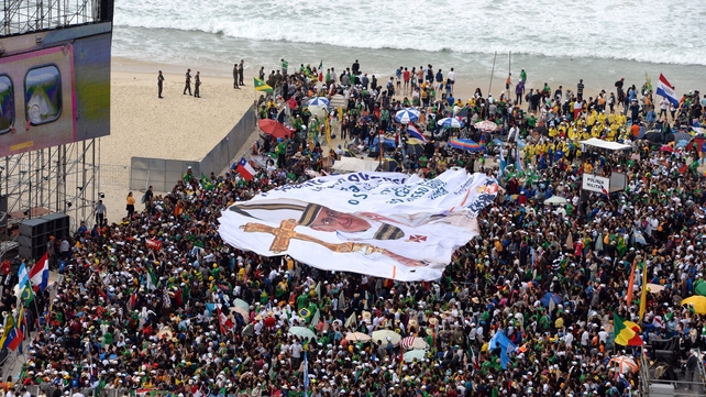 A huge banner with an image of Pope Francis is spread out at Copacabana beach