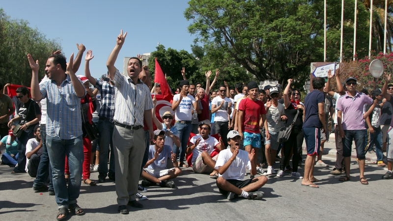 Protesters shout slogans against the ruling Ennahda party