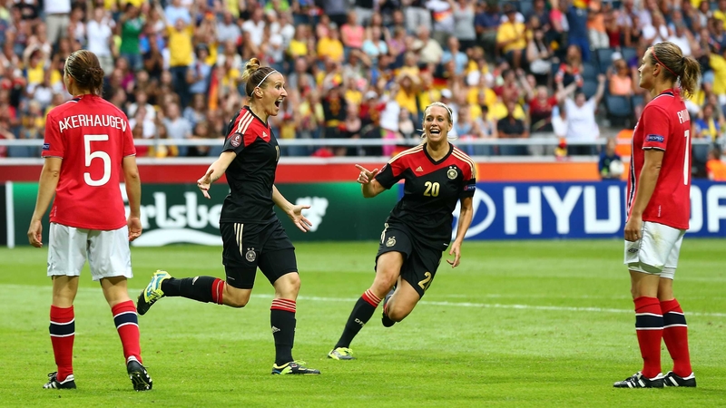 Anja Mittag (left) of Germany celebrates after she scores Germany's winning goal