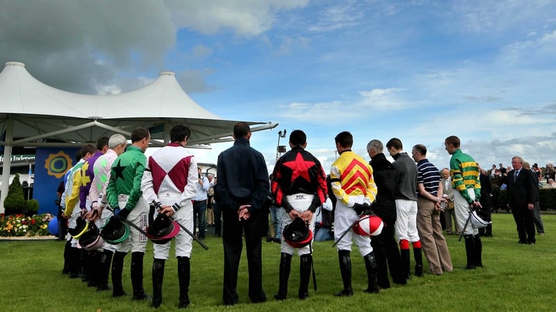 Jockey's observe a minute's silence in memory of RTE's Colm Murray ahead of the first race in Galway