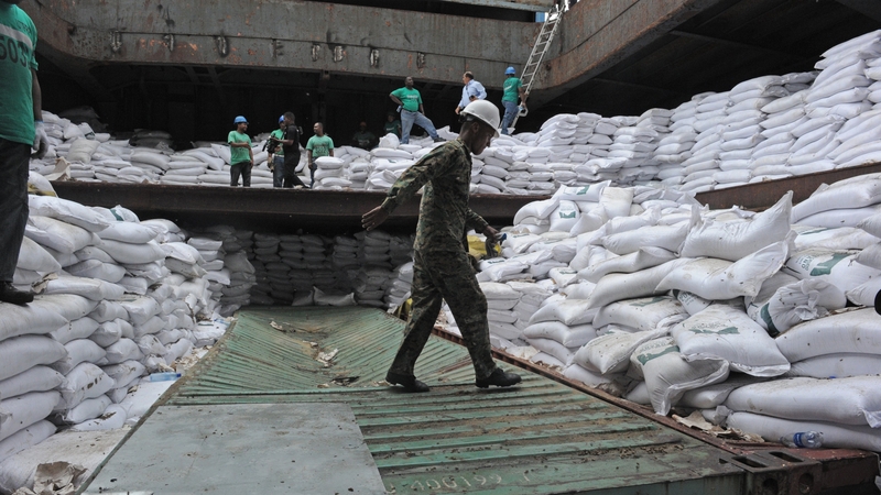 A police officer inspects containers inside the hold of the Chong Chon Gang