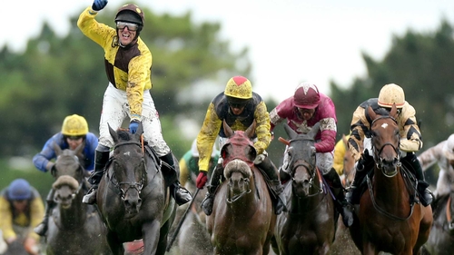 Robbie Power raises his fist in delight as he crosses the winning line aboard Missunited