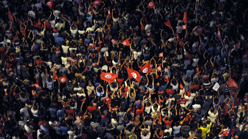 Crowds gathered yesterday in Tunis in protest at the Islamist government