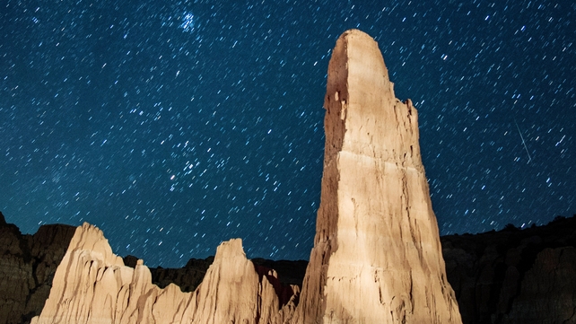 A meteor streaks across the sky above Cathedral Gorge State Park in Nevada, US