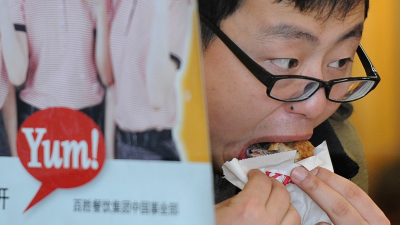 A customer eating KFC at one of its Shanghai restaurants